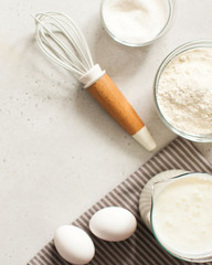  Ingredients for baking with flour and a culinary whisk with space for text, recipe. The concept of food minimalism.