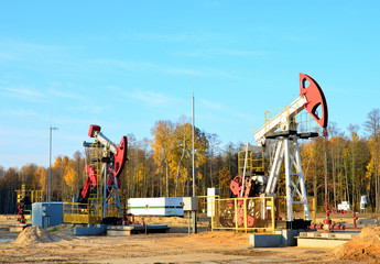 Oil drilling derricks at desert oilfield for fossil fuels output and crude oil production from the...