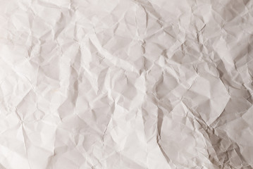 Crumpled white paper background.