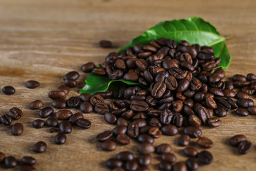 Fototapeta premium Coffee beans on wooden table with copyspace for text. Selective focus.