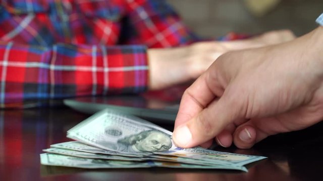 Boss paying salary to employee working in office
