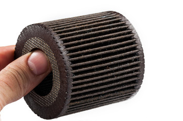 Old and dirty oil filter isolated on white background.Copy space