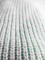Macro close up on soft knitted fabric texture detail background