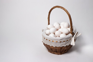 Fototapeta na wymiar Easter wicker basket from a natural vine with eggs. Beautifully designed baskets in a minimalist style.