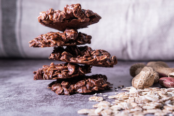 Healthy  no-bake oatmeal cookies pile made with peanut butter and chocolate powder. Vegan snack. Close up view.