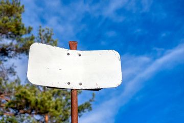 White old signpost on ruty pole