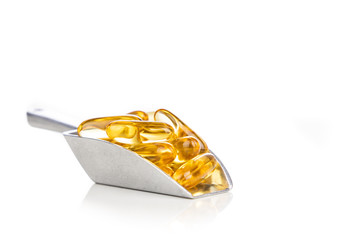 Scoop of fish oil gel capsule containing omega-3 polyunsaturated acid EPA and DHA enhances heart...