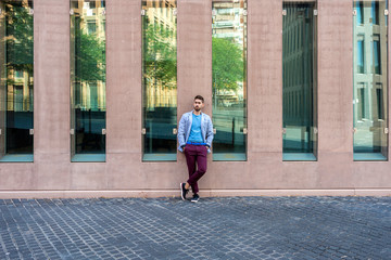 Young bearded man, model of fashion, in urban background wearing casual clothes.