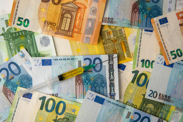 coronavirus vaccine on euro banknotes background