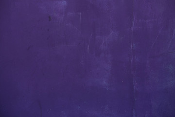 Old purple bright stone wall with traces of chalk inscriptions