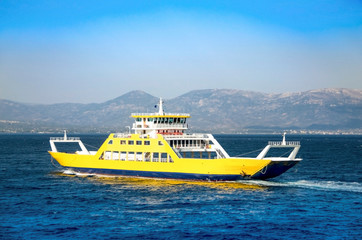 Yellow ferryboat for the transport of people and cars