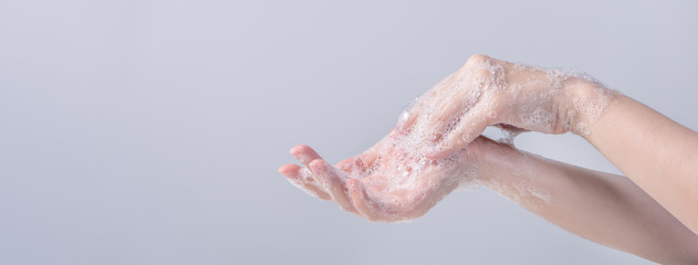 Washing hands. Asian young woman using liquid soap to wash hands, concept of hygiene to protective...