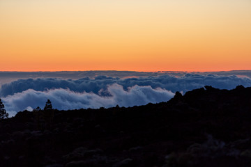 Naklejka premium Detail of the clouds under the mountain during a sunset in Teide mountain, Tenerife, Canary Islands, Spain
