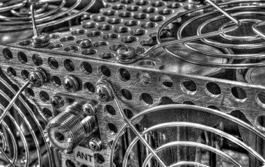 Rear panel of a high frequency power amplifier with vacuum tubes in black and white