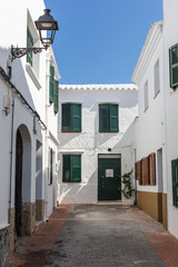 Alley with white houses in Menorca, Balearic Islands, Spain