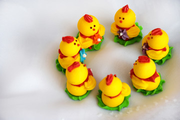 Easter concept, top view. Close up Group Easter chickens on white background. Yellow beautiful Easter decor of chickens on selective focus with copy space for text. minimalism