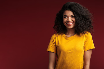 Image of beautiful brunette african american woman with curly hair smiling