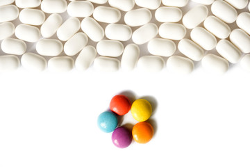 Pills and tablets on bright white background, healthcare medical concept, antibiotics and cure, top view copy space.One bright tablet,Leader concept, thinking out the box