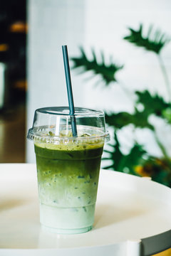 Iced green tea in takeaway cup in coffee shop
