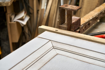 MDF cabinet door. Joinery. Gluing and clamping MDF cabinet door in workshop. Furniture manufacture