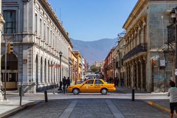 A yellow taxi cab drives throught the road near the main street in Oaxaca de Juárez, Mexico. Some...