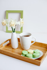 romantic morning greeting card. Wooden breakfast tray with a bouquet of spring flowers in bed