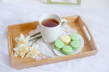 romantic morning greeting card.a Cup of morning tea with macaroons and a flower