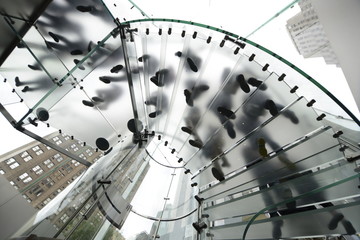 Silhouette people walking on transparent stairs. Urban living, modern glass architecture, business and lifestyle concept