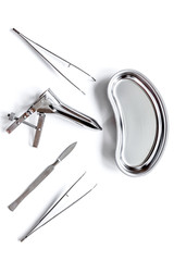 instruments of gynecologist on white background top view
