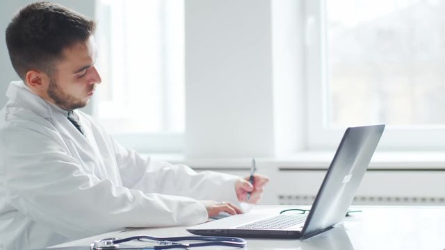 Professional medical doctor working in hospital office using computer technology. Medicine and healthcare.