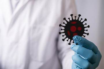 doctor holding a virus in the hand