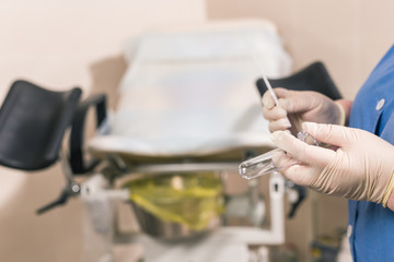 Close-up of doctor hand holds gynecological examination instruments. Gynecologist working in the obstetrics and gynecology department. Medical concept.