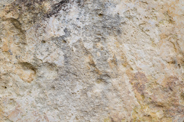The texture of the stone wall, grey and beige colors