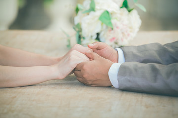 Obraz na płótnie Canvas bride and groom holding hands a symbol of love