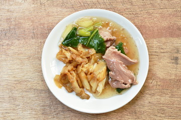stir fried rice noodles with slice fermenting pork and Chinese kale in gravy sauce on plate