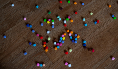 multi-colored fluffy lumps lie on the floor