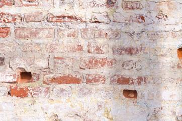 Grange an old brick wall with peeling paint