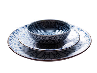 Top view of beautiful round ceramic plate flower pattern porcelain dish isolated on blue background.