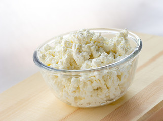 curd in a glass bowl on wooden background