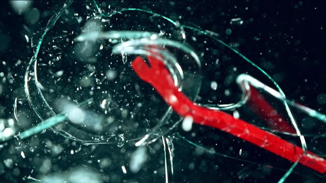 Super Slow Motion Shot of Crowbar Glass Break at 1000 fps Isolated on Black Background.