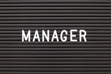 Black color felt letter board with white alphabet in word manager background