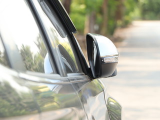 The right side mirror of the car is folded to prevent collisions.