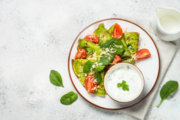 Green pancakes from spinach on white top view.