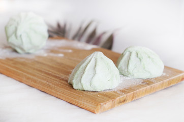 Marshmallows on a wooden board, decoration with a twig
