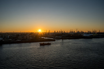 Fototapeta premium Panoramic view of the Port of Hamburg in the Hafen City at Elbe river at sunset/twilight