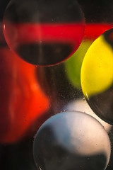 balls of sunflower oil on water similar to space planets from another galaxy