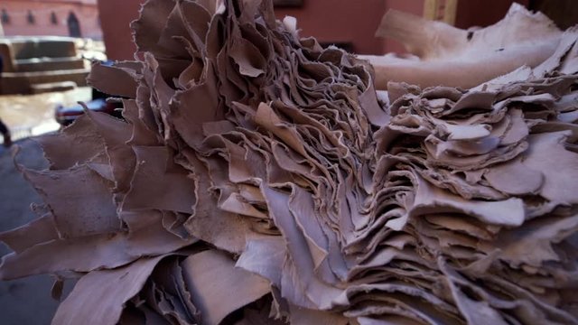 Stack of dried goatskin in the sunlight of the tanners district. Leatherworking in the Medina of Marrakesh.