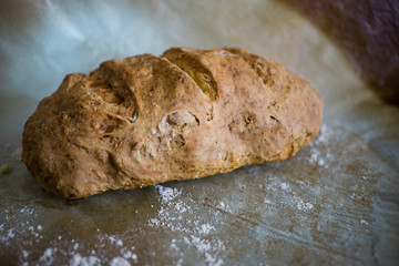 Close-up of a fresh homemade bread on baking paper 