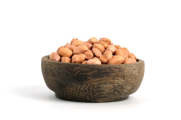 Closeup raw peanuts on wooden bowl isolated white background
