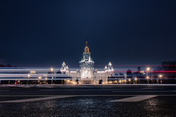 Fototapeta premium Russia, Moscow, Vorobyovy Gory, skyscraper of Moscow State University. Winter landscape, night illumination of the Stalinist skyscraper. Evening walk in the city lights